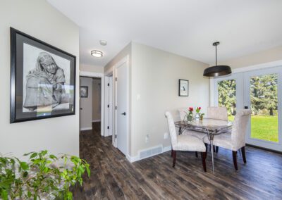 A dining room featuring a wooden table surrounded by elegant chairs, creating a warm and inviting atmosphere.