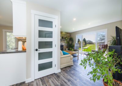 A cozy living room featuring a white door and a comfortable couch, creating a welcoming atmosphere for relaxation.