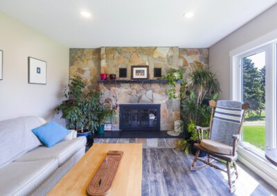 A cozy living room featuring a warm fireplace and a comfortable couch, creating an inviting atmosphere for relaxation.