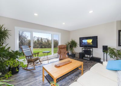 A cozy living room featuring a television, a comfortable chair, and a stylish table, creating a welcoming atmosphere.